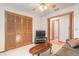 Living room area features a comfortable couch, table, TV, ceiling fan and closet space at 929 N Lakewood Ter, Port Orange, FL 32127