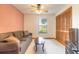 Living room area features a comfortable couch, window, ceiling fan and closet space at 929 N Lakewood Ter, Port Orange, FL 32127
