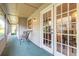 Outdoor patio with seating area and entry into home through french doors at 929 N Lakewood Ter, Port Orange, FL 32127