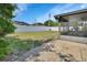 Backyard with a partial view of screen-enclosed porch, privacy fence and mature landscaping at 953 Tulip St, Deltona, FL 32725