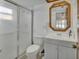 Bathroom with a glass-enclosed shower, white vanity, and stylish mirror at 953 Tulip St, Deltona, FL 32725