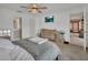 Bright bedroom featuring neutral decor, a ceiling fan, and an en-suite bathroom at 953 Tulip St, Deltona, FL 32725