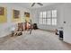 Bedroom with carpet flooring and a window with shutters and a yellow accent wall at 953 Tulip St, Deltona, FL 32725
