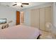 Light and airy bedroom with ceiling fan, closet and pink quilt on full size bed at 953 Tulip St, Deltona, FL 32725
