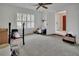 Bedroom with carpet flooring, a window with shutters, and an open doorway at 953 Tulip St, Deltona, FL 32725