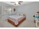 Bedroom with white walls, tile flooring, a ceiling fan and a window with wood shutters at 953 Tulip St, Deltona, FL 32725
