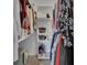 Walk-in closet with built-in shelving and rods for ample storage at 953 Tulip St, Deltona, FL 32725