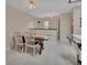 Bright dining area featuring a wooden table with white chairs that adjoins the kitchen island and seating area at 953 Tulip St, Deltona, FL 32725