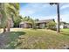 Attractive single-Gathering home featuring a large front yard, mature landscaping and palm trees at 953 Tulip St, Deltona, FL 32725
