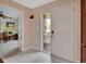 Bright entryway featuring white tile flooring, a decorated front door, and open access to other rooms at 953 Tulip St, Deltona, FL 32725