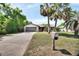 Inviting single Gathering home with palm trees, well-maintained lawn, and a long driveway at 953 Tulip St, Deltona, FL 32725