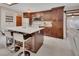 Modern kitchen boasting dark wood cabinetry, white countertops, a spacious island, and stainless steel appliances at 953 Tulip St, Deltona, FL 32725