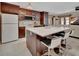 Spacious kitchen with a large center island, dark wood cabinetry, and modern bar seating that complements the open layout at 953 Tulip St, Deltona, FL 32725