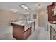 The kitchen features an island with seating, seamlessly blending into the dining area with plenty of natural light at 953 Tulip St, Deltona, FL 32725