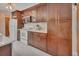 Well-equipped kitchen with dark wood cabinets, tiled backsplash, stainless appliances, and ample counter space for cooking at 953 Tulip St, Deltona, FL 32725