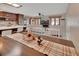 Open-concept living and kitchen area with wooden cabinets, a breakfast bar, and neutral-toned furniture at 953 Tulip St, Deltona, FL 32725