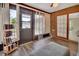 Sunroom with wood floors, ceiling fan, brick wall and door leading to outdoor space at 953 Tulip St, Deltona, FL 32725
