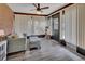 Living Room with light-grey, cozy furniture, grey wood floors and bright natural light at 953 Tulip St, Deltona, FL 32725