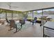 Spacious screened patio with ceiling fan, grill, patio table and outdoor furniture at 953 Tulip St, Deltona, FL 32725