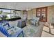 Screened patio with brick floor, ceiling fan, outdoor furniture and BBQ at 953 Tulip St, Deltona, FL 32725