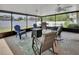 Screened-in patio with multiple seating areas, ceiling fan, grill and view to backyard at 953 Tulip St, Deltona, FL 32725
