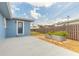 Charming backyard featuring a garden bed, a concrete patio, a wooden fence, and a well-manicured lawn at 1032 Bel Aire Dr, Daytona Beach, FL 32118