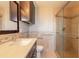 Modern bathroom featuring a glass-door shower, a stylish vanity with neutral countertops, and updated fixtures at 1032 Bel Aire Dr, Daytona Beach, FL 32118