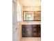 Modern bathroom featuring dual sinks, custom cabinets, tiled floor and a large mirror at 1032 Bel Aire Dr, Daytona Beach, FL 32118