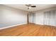 Spacious bedroom boasting sleek hardwood floors, neutral walls, a ceiling fan, and multiple closets at 1032 Bel Aire Dr, Daytona Beach, FL 32118