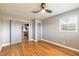 A serene bedroom featuring hardwood floors, a ceiling fan, and access to the kitchen at 1032 Bel Aire Dr, Daytona Beach, FL 32118