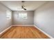 A spacious room with hardwood floors, a ceiling fan, and plenty of natural light at 1032 Bel Aire Dr, Daytona Beach, FL 32118