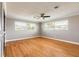 Bright bedroom with hardwood floors, a ceiling fan, and sun-filled windows at 1032 Bel Aire Dr, Daytona Beach, FL 32118