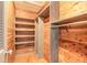 Spacious walk-in closet boasting wood paneling, built-in shelving, and ample hanging space for organized storage at 1032 Bel Aire Dr, Daytona Beach, FL 32118