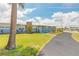 A beautiful single story home featuring a stone accent column, fresh exterior paint, and a large palm tree at 1032 Bel Aire Dr, Daytona Beach, FL 32118