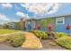 Single story home featuring gorgeous landscaping, a well-manicured lawn, and a freshly painted exterior at 1032 Bel Aire Dr, Daytona Beach, FL 32118