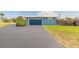 Side view of single story home with a dark blue garage door and matching trim at 1032 Bel Aire Dr, Daytona Beach, FL 32118