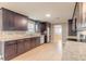 Well-lit kitchen featuring dark wood cabinets, granite countertops, and stainless steel appliances at 1032 Bel Aire Dr, Daytona Beach, FL 32118