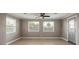 Bright living room featuring tiled floor, a ceiling fan and sun-filled windows at 1032 Bel Aire Dr, Daytona Beach, FL 32118