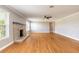 Spacious living room with hardwood floors, light gray paint, and a brick fireplace at 1032 Bel Aire Dr, Daytona Beach, FL 32118