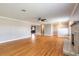 Bright and airy living room featuring hardwood floors, crown molding, and a stone fireplace at 1032 Bel Aire Dr, Daytona Beach, FL 32118