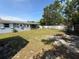 Large, grassy backyard with a white fence and mature trees at 1081 Cobblestone Ave, Deltona, FL 32725
