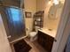 Bathroom featuring a stall shower, toilet, and vanity with a dark wood base at 1081 Cobblestone Ave, Deltona, FL 32725