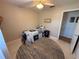 Neutral bedroom with ceiling fan and a bed with blue and white quilt at 1081 Cobblestone Ave, Deltona, FL 32725