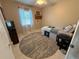 Bedroom features ceiling fan, window with white curtains, and carpeted flooring at 1081 Cobblestone Ave, Deltona, FL 32725