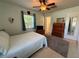 Bedroom features ceiling fan, neutral walls, a window, and a wood dresser at 1081 Cobblestone Ave, Deltona, FL 32725