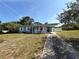 Charming single-story home featuring a cozy front porch and a convenient covered carport at 1081 Cobblestone Ave, Deltona, FL 32725