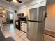 Bright kitchen with stainless steel refrigerator, black appliances, and white cabinets at 1081 Cobblestone Ave, Deltona, FL 32725