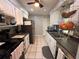 Functional kitchen with white cabinets, black appliances, and tile floors, offering a practical cooking space at 1081 Cobblestone Ave, Deltona, FL 32725