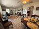 Open-concept living and dining area with tile floors, comfortable seating, and kitchen access at 1081 Cobblestone Ave, Deltona, FL 32725