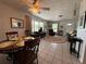 Inviting living room and dining area with tile floors, comfortable seating, and natural light at 1081 Cobblestone Ave, Deltona, FL 32725